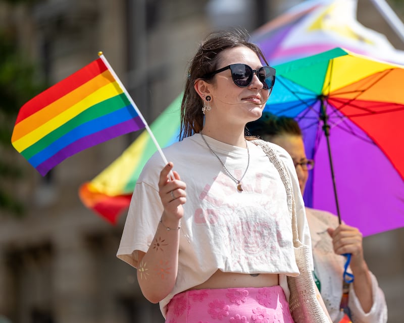 Erin Wilson waves Pride flag whilst walking in the 5th annual Ottawa Family Pride Festival parade on June 13, 2026 on Lasalle St. in Ottawa.