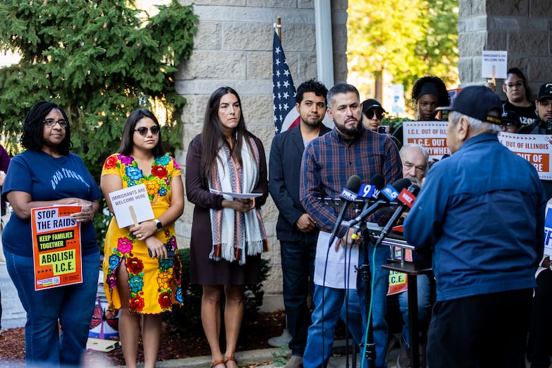 Sherry Williams, Destinee Ortiz, Lorena Guerrero, Ceasar Guerrero, and Marcos Ceniceros listen as Joe Bellman addresses the crowd during a press conference held to uplift immigrant families and denounce the presence of the Texas National Guard in Will County at Azteca de Oro in Joliet on Oct. 8, 2025.