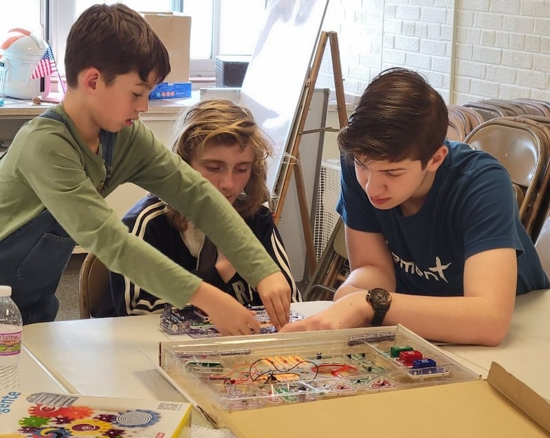 Shown are Luis Smith, David Bagwell and David Wehler working on a snap circuit.