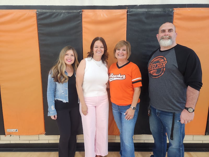 Beecher Junior High Principal Michelle Kwasny, District Special Education Coordinator Dawn Compton, retiree Amy Propper and Superintendent Jack Gaham pose for a photo after longtime staff and retirees were honored for their service at a May 2025 assembly.