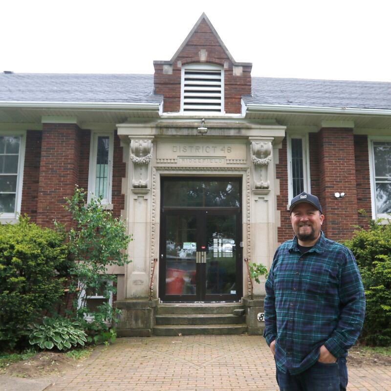 Brent Hollenberg in front of the former Ridgefield schoolhouse at 8617 Ridgefield Road, near Crystal Lake on Wednesday, May 21, 2025. Hollenberg plans to turn the schoolhouse into a six-unit Airbnb. The building was last the home of the McHenry County Jewish Congregation.