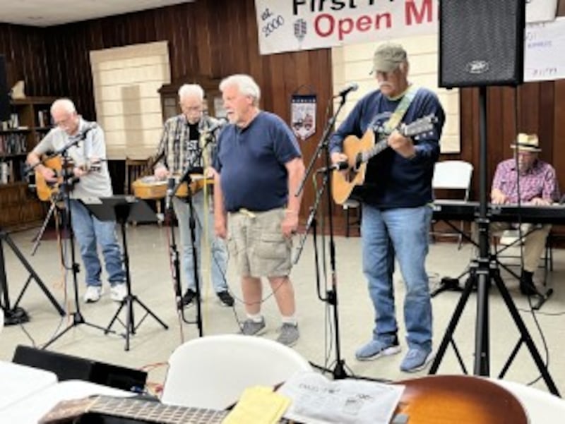 Randy Holland (center) is a popular singer and harmonica player at First Fridays, as well as a member of the First Fridays operating committee.