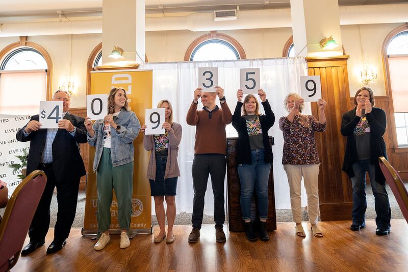 Representatives hold up the amount the Lee County United Way raised during its 2024-25 campaign. It was announced Thursday, May 1, 2025, that $409,359 went to community organizations.