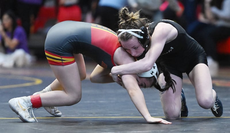 Montini’s Katelyn Bell, right, wrestles Batavia’s Lily Enos in the 100-pound final match during the Schaumburg girls wrestling sectional Saturday.