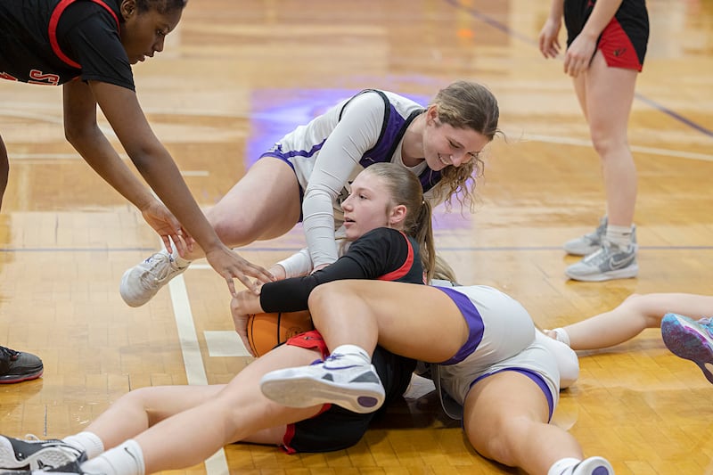 Dixon and Stillman Valley players scramble on the floor for a loose ball Saturday, Feb. 7, 2026.