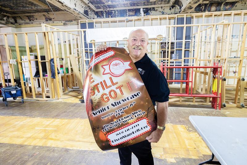 Dixon Stage Left artistic director Jimmy Ferraro shows off a poster, Thursday, Sept. 3, 2025, for the upcoming Senior Showcase talent event. Stage Left’s headquarters is undergoing renovations, which moved the performance to The Next Picture Show.