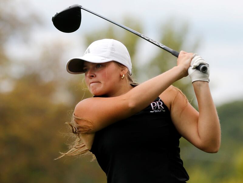 Prairie Ridge’s Grace Mertel watches her tee shot on the 14th hole during the Fox Valley Conference Girls Golf Tournament Wednesday, Sept. 24, 2025, at Crystal Woods Golf Club in Woodstock.