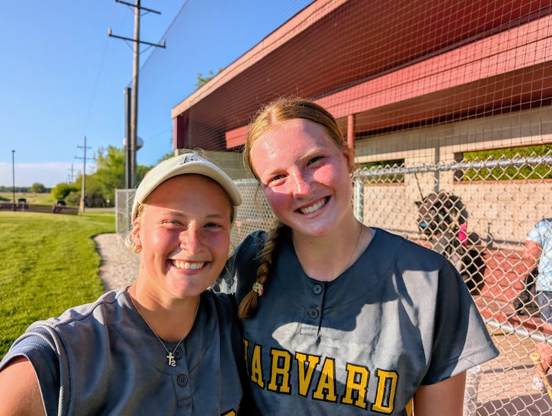 Harvard softball sisters Tallulah (left) and Leona Eichholz pose for a picture after the Hornets' 1-0, nine-inning win over Richmond-Burton in the teams' Kishwaukee River Conference finale Wednesday, May 14, 2025, in Richmond.