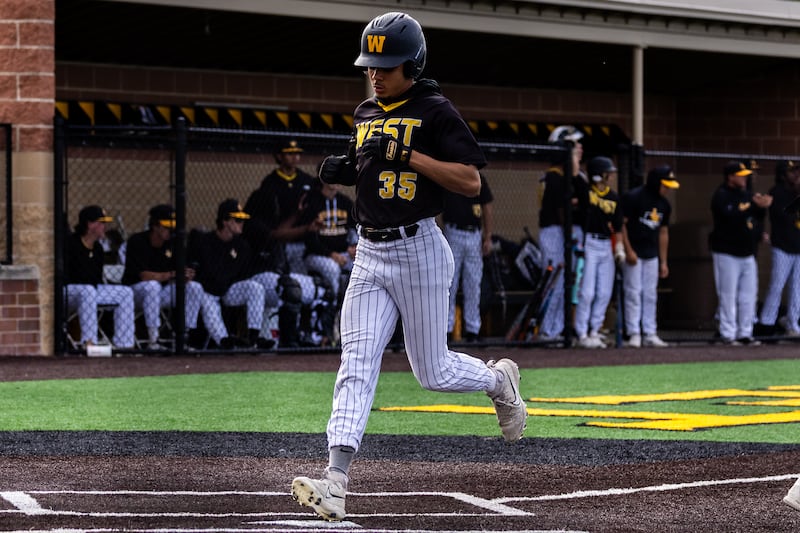 Joliet West's Isaac Harris crosses home plate during a varsity baseball game against Joliet Central at Joliet West on May, 21, 2026.