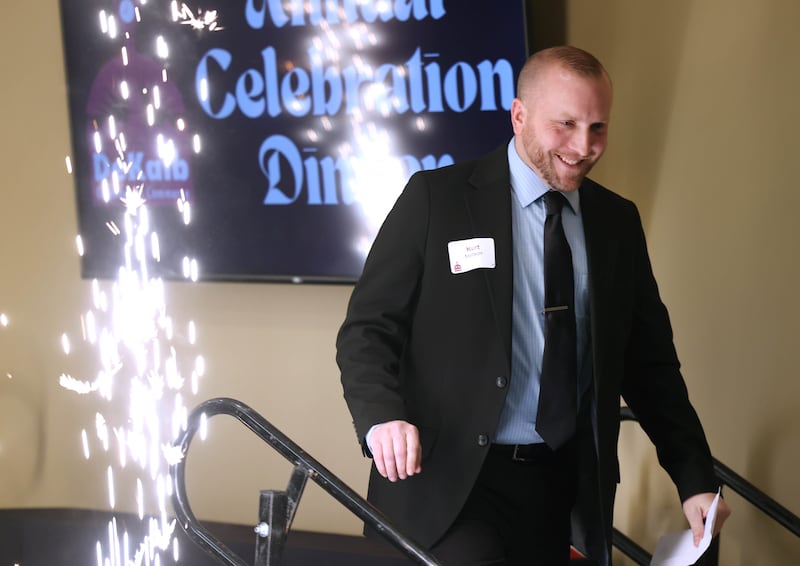 Kurt Mattson, from DeKalb Mechanical, walks past the sparklers to accept the Business of the Year Award on behalf of DeKalb Mechanical Thursday, Feb. 5, 2026, during the DeKalb Chamber of Commerce Annual Celebration Dinner at Faranda's Banquet & Conference Center.