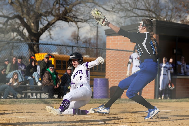 Wilmington's Sami Liaromatis slides safely into home as Central's Sydney Jemar looks to tag during the Wildcats' 22-5 victory over the Comets on Wednesday, March 26, 2025.