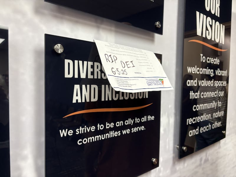 A sign reading "RIP DEI 6-5-25" on a plaque in the Crystal Lake Park District board meeting room June 5, 2025.