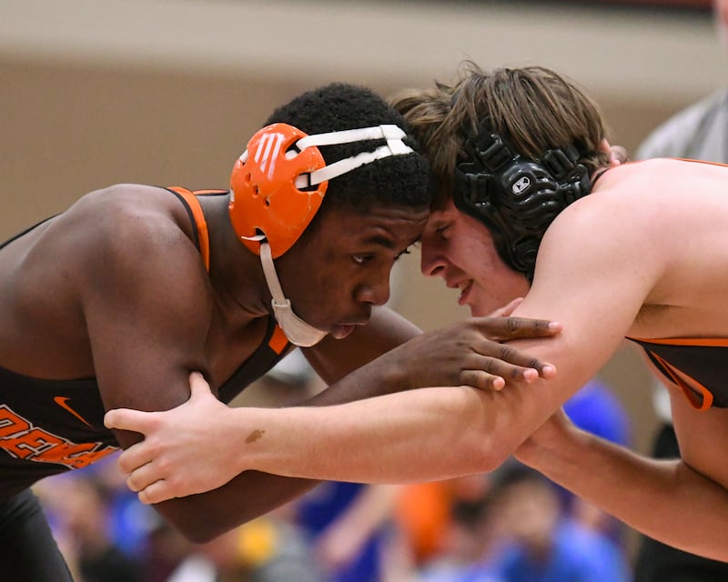 DeKalb’s Hussul Greer, left, wrestles against St. Charles East’s Ben Guskiewicz in the 175-weight class on Monday, Dec. 29, 2025, during the Flavin Invitational held at DeKalb High School.