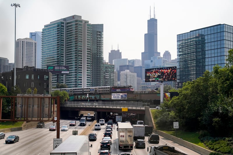 A Metra commuter train operated by Illinois' Regional Transportation Authority travels to downtown Chicago over Kennedy Expressway on interstate 90 and 94 Wednesday, Sept. 14, 2022, in Chicago. Business and government officials are preparing for a potential nationwide rail strike at the end of this week while talks carry on between the largest U.S. freight railroads and their unions. (AP Photo/Kiichiro Sato)