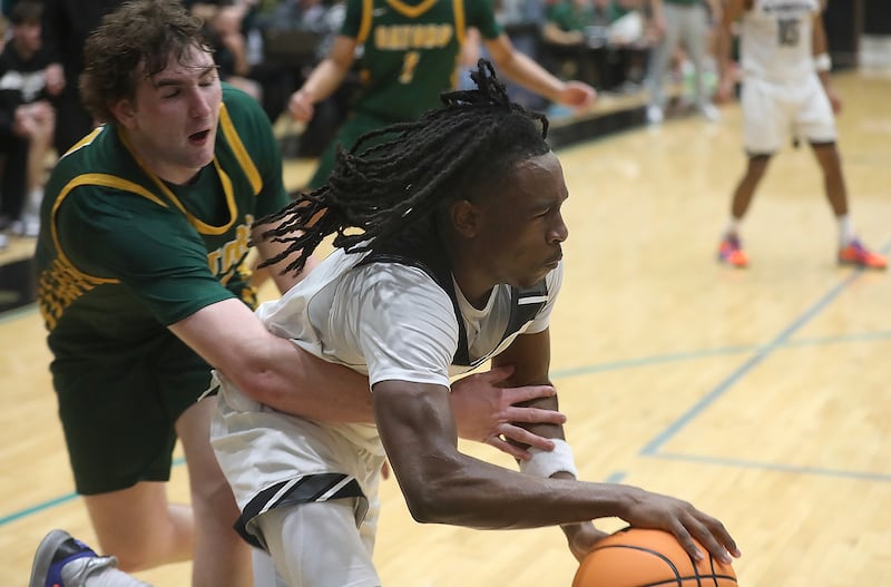 Kaneland's Marshawn Cocroft drives the baseline as Crystal Lake South's Ryan Morgan tries to steal the ball during the IHSA Class 3A Woodstock North Sectional final basketball game on Friday, March 6, 2026, at Woodstock North High School.