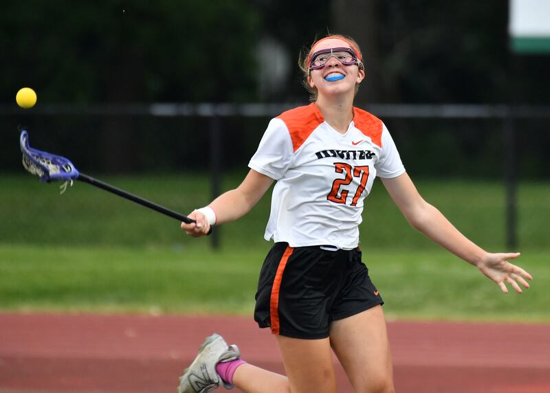 Crystal Lake’s Anna Starr flips the ball away with glee as the clock runs out on the Benet Supersectional game against Downers Grove South on June 3, 2025 at College of DuPage in Glen Ellyn.