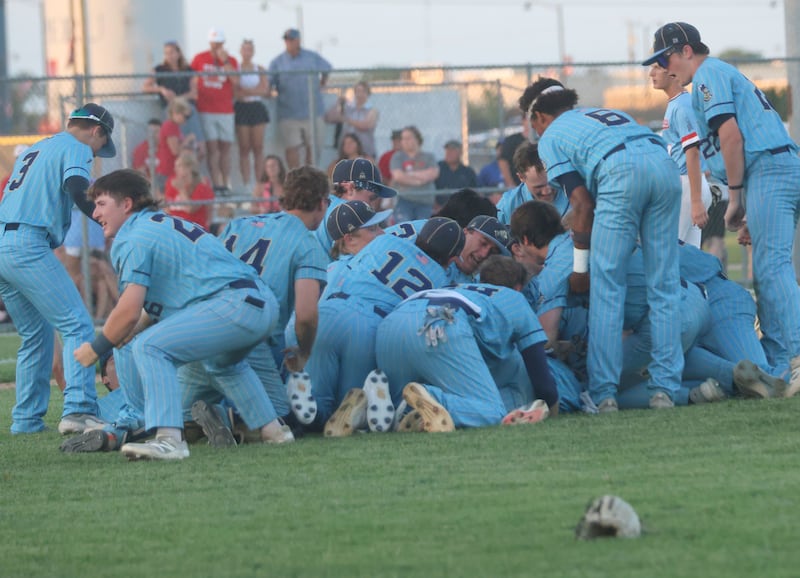 Members of the Marquette baseball team dog pile on the mound after defeating Brimfield during the Class 2A Supersectional game on Tuesday, June 9, 2026 at Schweickert Stadium in Peru.