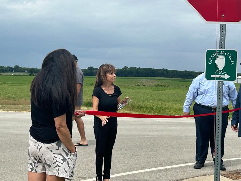 Harvard Alderwoman Rosa Luna, 4th Ward, cuts ribbon on Saturday, June 8, 2024, during the ceremony naming the entrance to Milky Way Park after her father, V.H. Garza. The Garza family was one of the first Spanish-speaking families in Harvard.