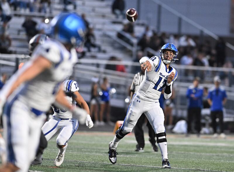 St. Charles North's Jesse Padron (12) throws a pss during the non-conference game against Minooka on Friday, Aug. 29, 2025, at Minooka.