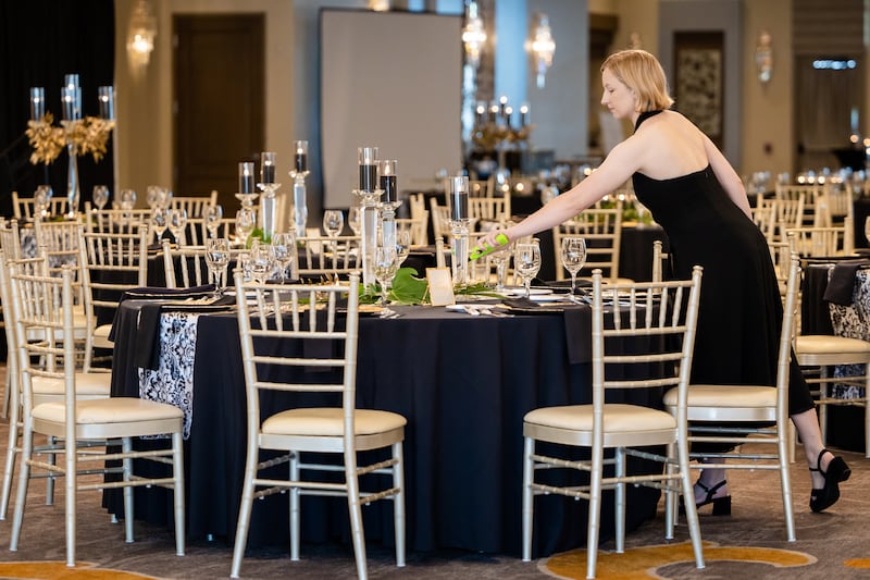 Events by Artful Decor President Amanda Keen sets up a table for an event.