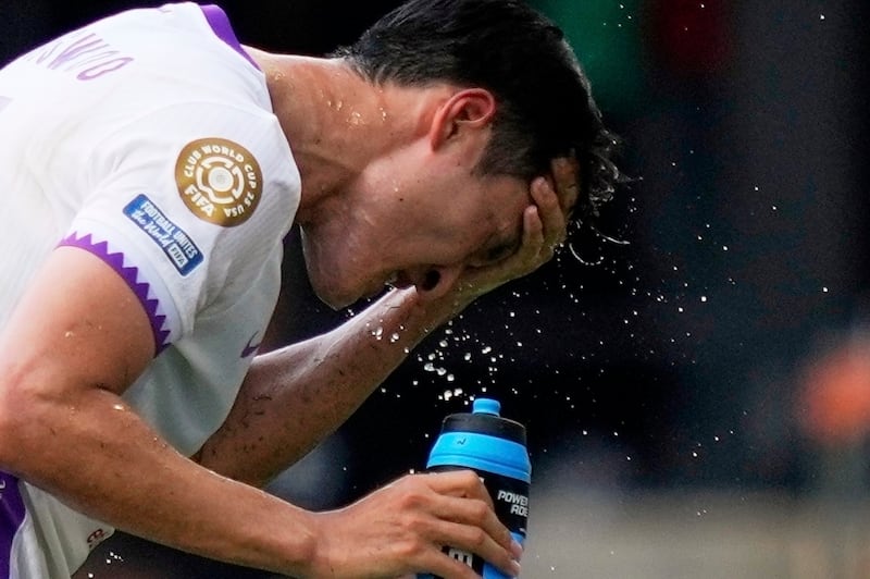 FILE - Al Ain's Park Yong-woo splashes his face to cool off during the Club World Cup Group G soccer match between Wydad AC and Al Ain FC in Washington, June 26, 2025. (AP Photo/Julia Demaree Nikhinson, File)