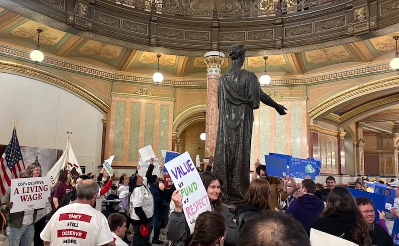 Members of the “They Deserve More” coalition flood the rotunda of the Illinois Statehouse, calling on lawmakers to pass wage increases for caretakers of those with intellectual and developmental disabilities
