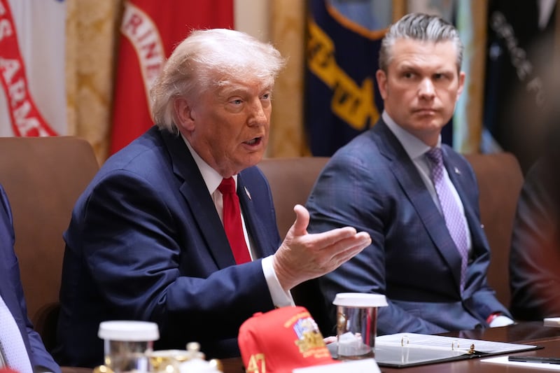 President Donald Trump speaks during a Cabinet meeting at the White House, Wednesday, May 27, 2026, in Washington, as Secretary of Defense Pete Hegseth, looks on. (AP Photo/Jacquelyn Martin)