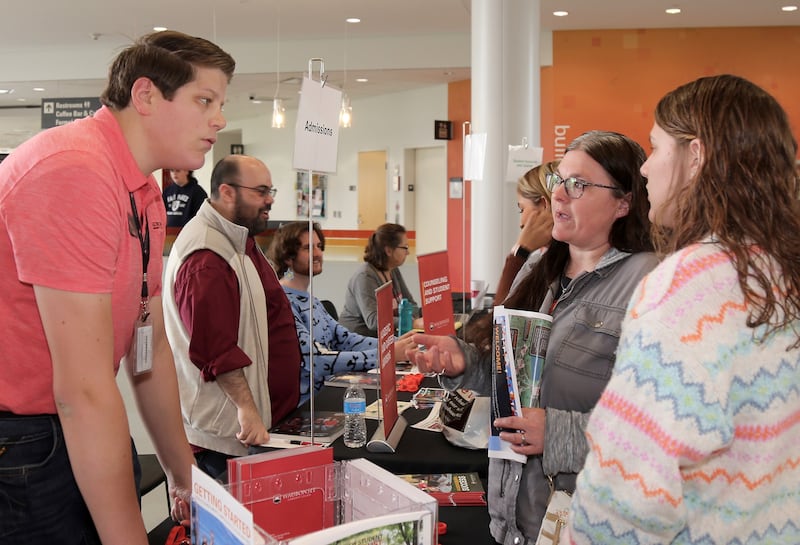 Brandon Slatton talks to Brenda and Emma Sparks, of Sandwich, at the Waubonsee Community College Transfer and Career Open House at the Sugar Grove Campus on April 20, 2024.