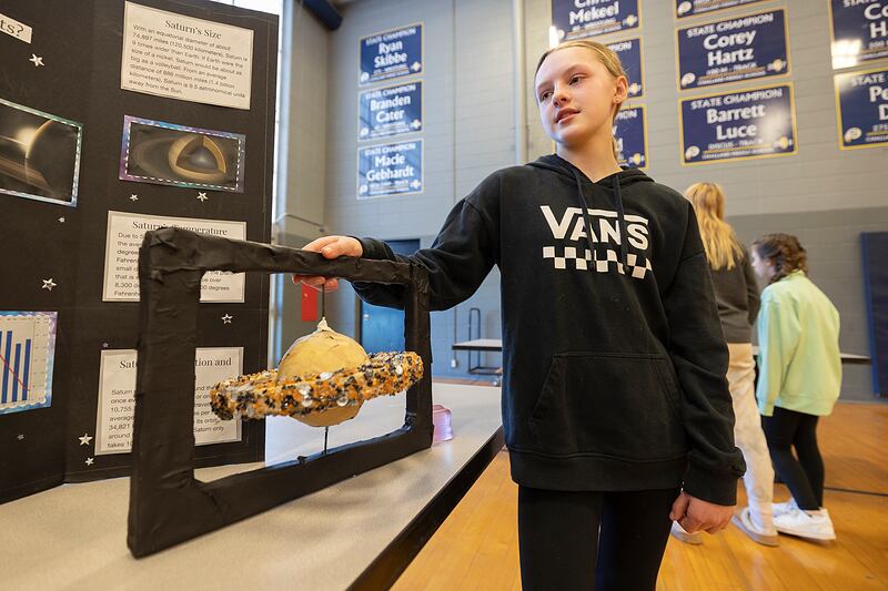 Emerson Slater, a sixth grader at Challand Middle School talks about her findings on Saturn Thursday, March 6, 2025, during the classes' STEM Fair. Fun fact: Saturn is the only planet that could float in water.