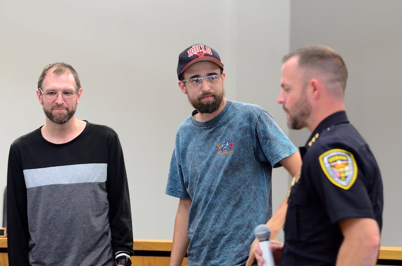 Dixon Police Chief Ryan Bivins (right) presents Dixon residents Jeremey Hunter (left) and Hayden Sweet (middle right) each an Award of Valor at a city council meeting Sept. 15, 2025.