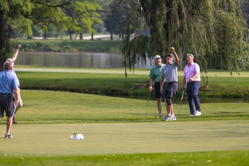 Phil Kambic, at right, president and CEO of Riverside Healthcare, celebrates with his foursome after sinking a putt during the 48th Annual Riverside Pro-Am on Friday, June 6, 2025.