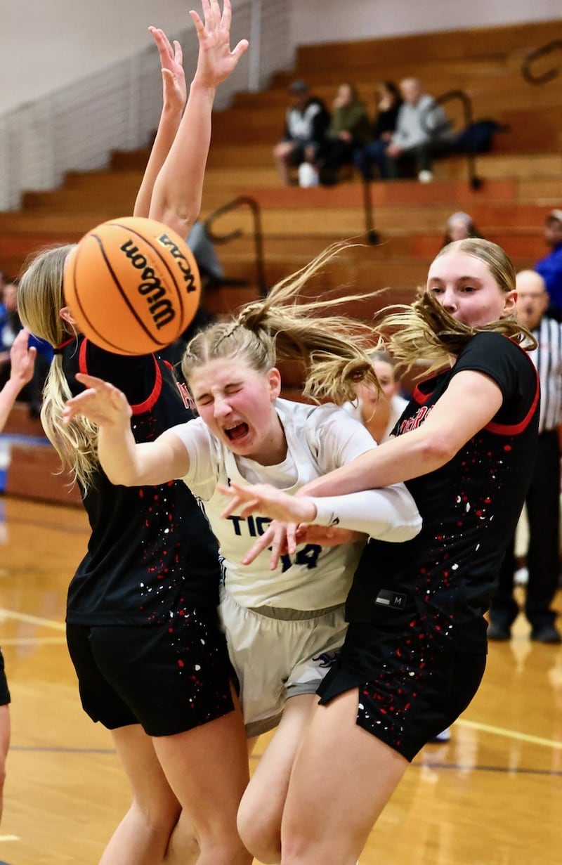 Princeton sophomore Payton Brandt feels the pinch between two E-P defenders Tuesday night at Prouty Gym. The visiting Panthers won 51-40.