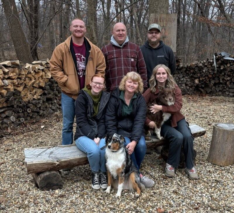 Princeton Police Chief Tom Kammerer of Princeton (center, standing) has announced his candidacy for Bureau County Sheriff. Pictured with Kammerer are (seated, from left) daughter Katie and wife Betsy (holding Lou the Aussie), daughter Maddy (holding Hazel) and (rear, from left) sons Lucas, Tom and Evan.