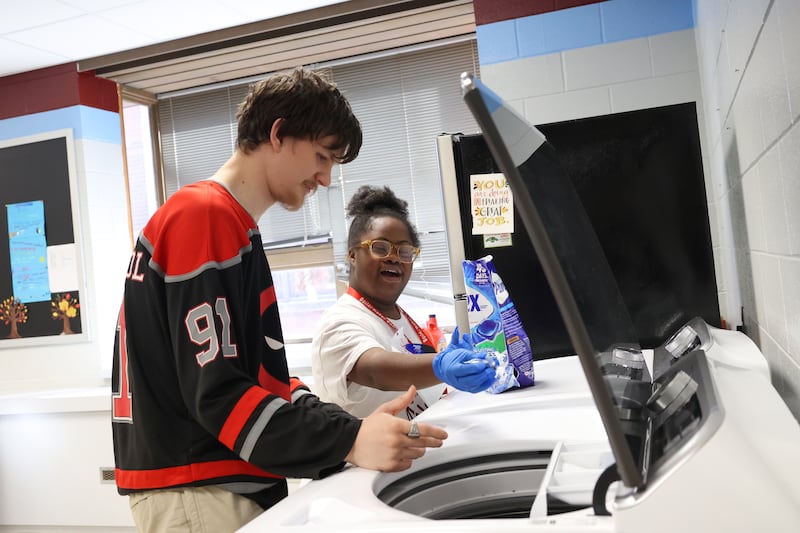 Kankakee School District students Precious Selvie, right, and Dakota Woodall practice starting a load of laundry at Kankakee School District's Avis Huff Student Support Services Center on Thursday, Nov. 13, 2025.