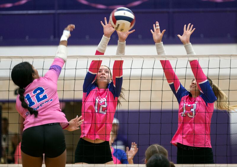 Dixon’s Izzy Queckboerner (left) and Solis Thompson against go for a block against Newman’s Gisselle Martin Thursday, Oct. 2, 2025.