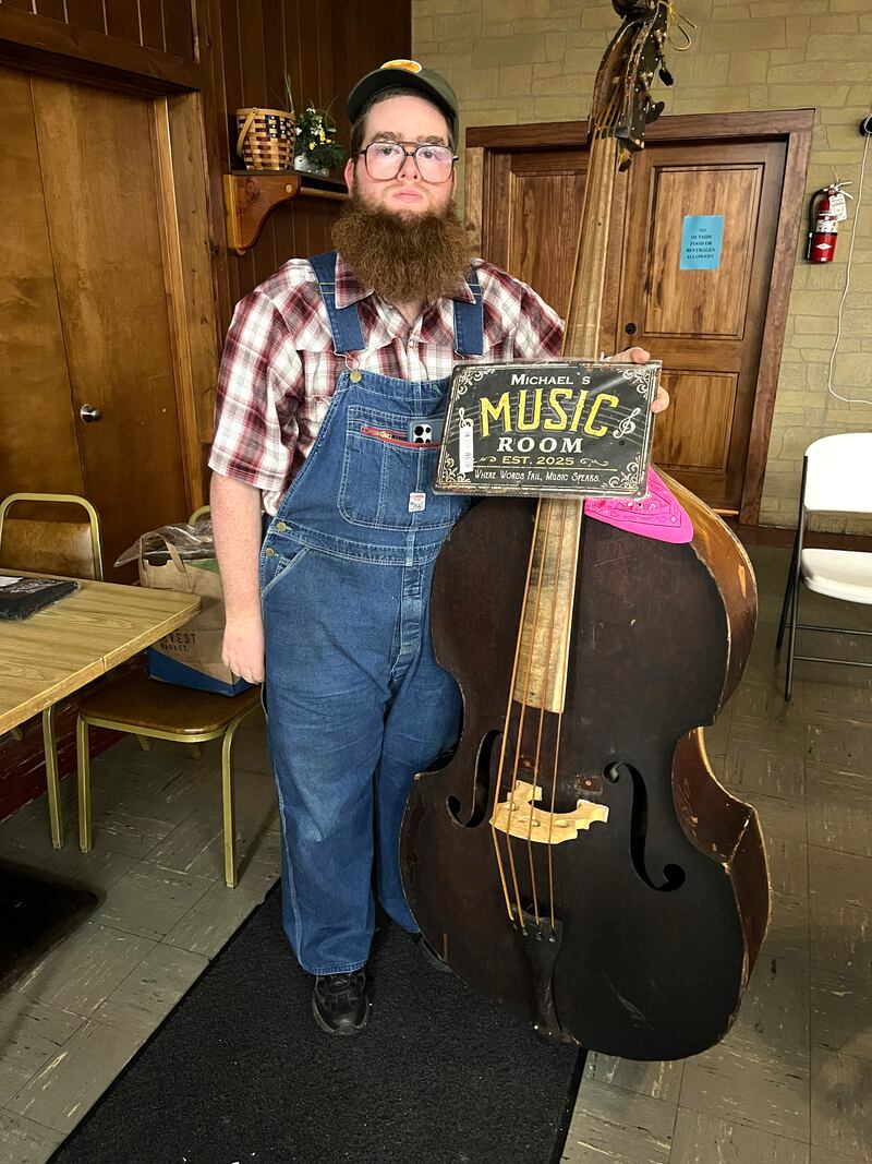 Claw hammer banjo player and sometime upright bass player Michael Mott was awarded a plaque at the last First Fridays show, in honor of his performances of authentic old-time folk music.