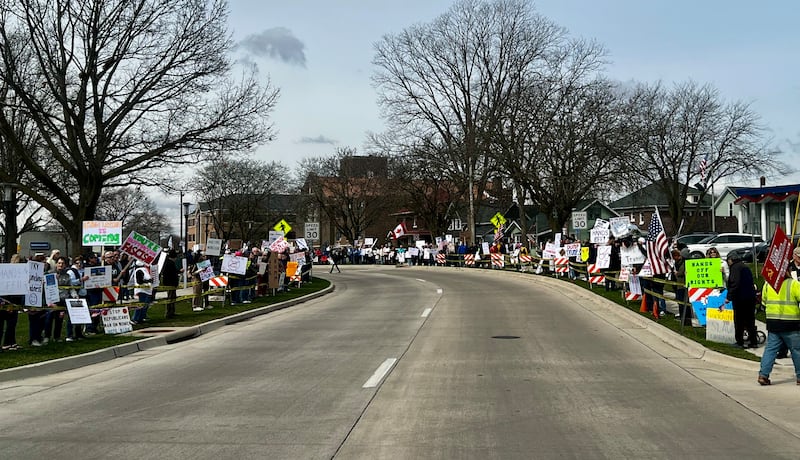 Hundreds of people gather in front of the Grandon Civic Center and the post office on Saturday, March 5, in Sterling, Illinois, to protest against President Donald Trump and his administration.