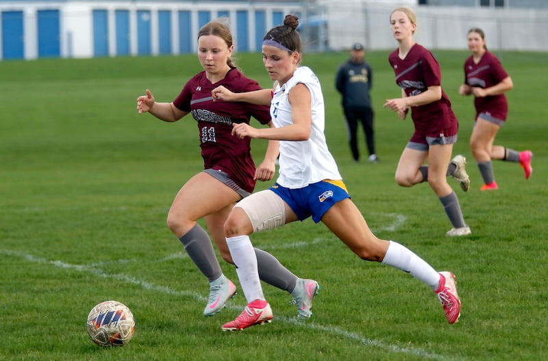 Johnsburg’s Liz Smith pushes the ball down the field against Marengo's Mackenzie Westwood during a Kishwaukee River Conference soccer match on Wednesday, April 15, 2026, at Marengo High School.
