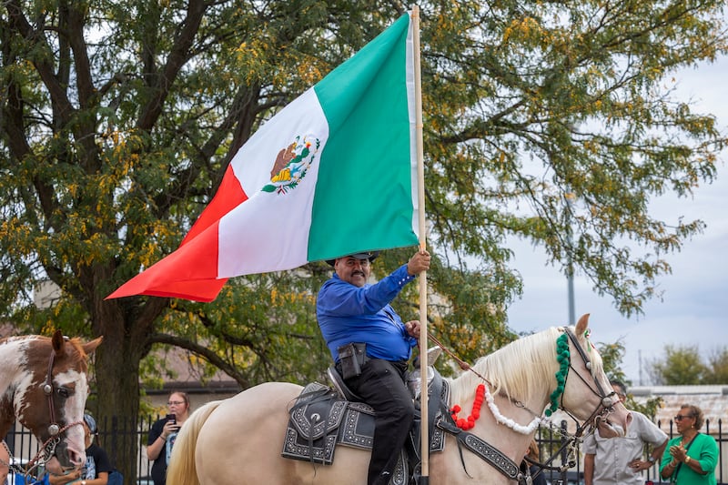 A flag bearer from Rancho El Capricho, displays the Mexican colors during the Fiesta Parade Saturday, Sept. 20, 2025, in Sterling.