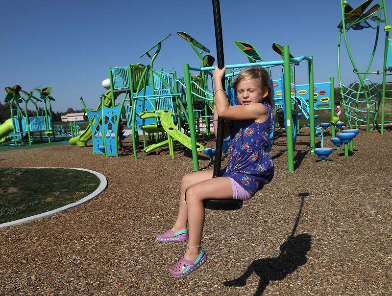 Charlotte Krause glides past the playground while playing on the zip line on Saturday, Sept. 27, 2025, at the playground at Crystal Lake Parks District’s new Lakewood Meadows Park.