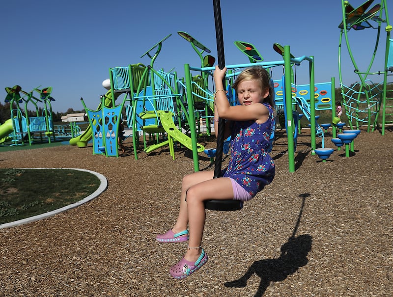 Charlotte Krause glides past the playground while playing on the zip line on Saturday, Sept. 27, 2025, at the playground at Crystal Lake Parks District’s new Lakewood Meadows Park.