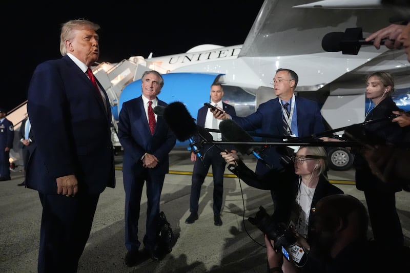 President Donald Trump talks with reporters before boarding Air Force One at John F. Kennedy International Airport in New York, early Tuesday, June 9, 2026. (AP Photo/Mark Schiefelbein)