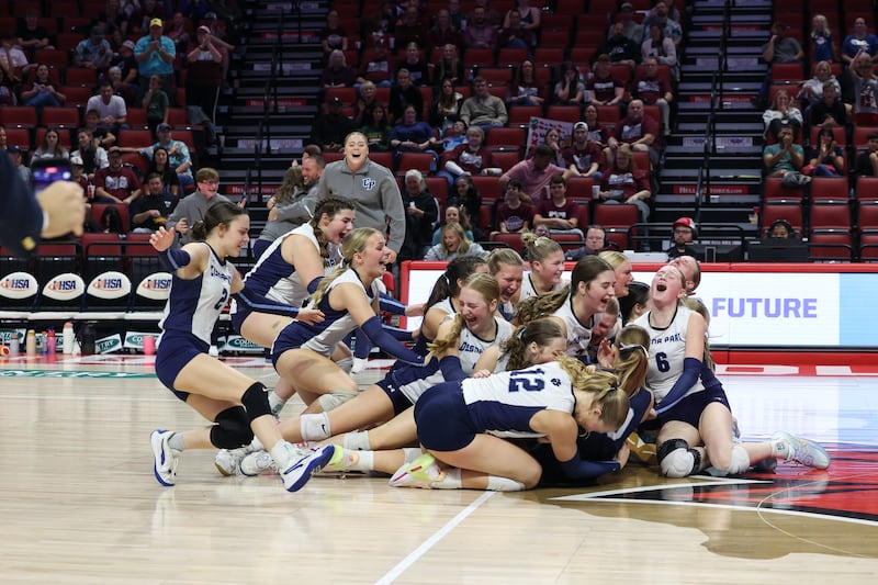 Cissna Park players celebrate on the floor as the Timberwolves secured a victory in two sets, 25-11, 25-14, over Stockton in the IHSA Class 1A State championship on Saturday, Nov. 15, 2025.