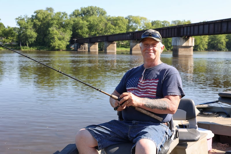James Swisher, of Kankakee, sits on his boat in Aroma Park before heading out to participate in the Kankakee River Fishing Derby on Thursday, July 3, 2025. Swisher, 71, recently disqualified himself and his 40-pound, 11-ounce flathead catfish catch from the derby’s leaderboard after realizing he didn’t meet rules of the competition.