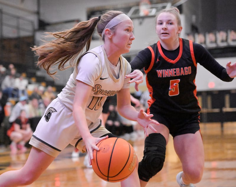 Sycamore's Cortni Kruizenga (10) drives past Winnebago's Grace Corl (5) during a game in Sycamore on Wednesday, Jan. 21, 2026.