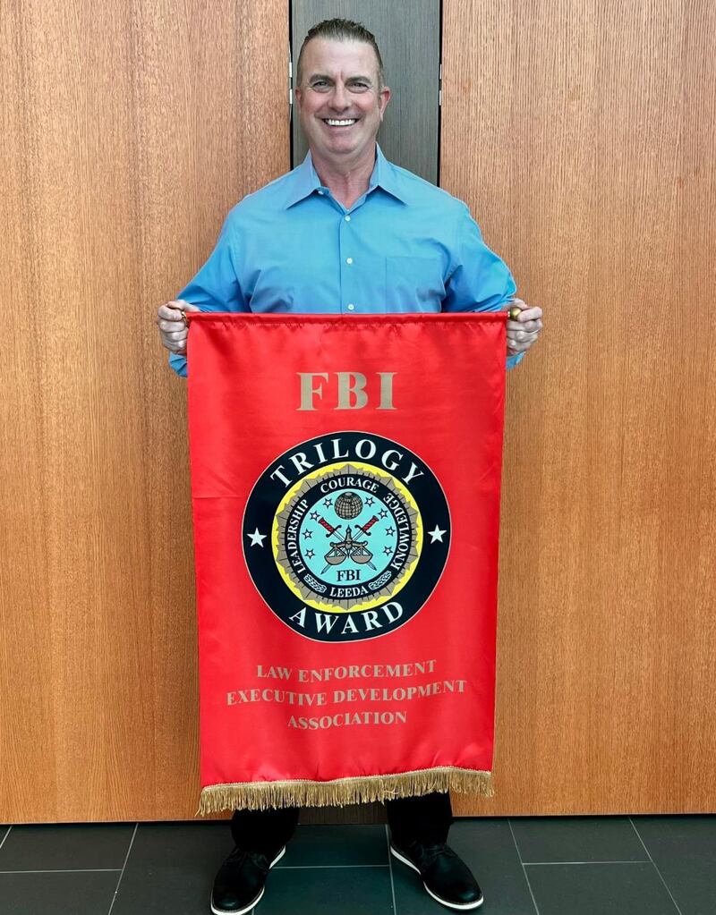 Montgomery Police Sgt. Jeff Ricedorf with the Trilogy Award from the FBI-LEEDA.