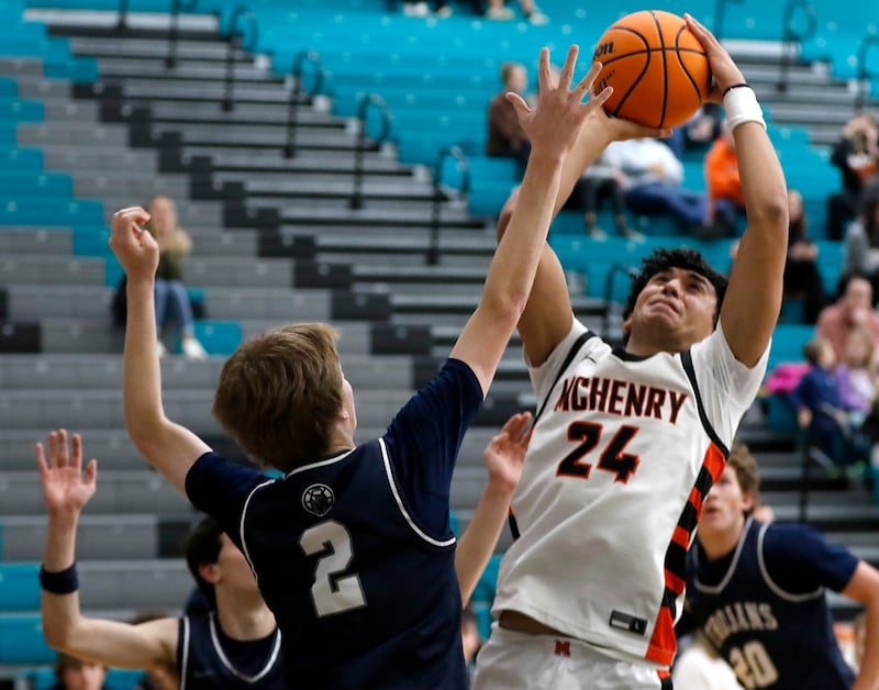 McHenry's Adam Anwar shoots the ball over Cary-Grove's AJ Berndt during the Woodstock Hoops for Healing Tournament Championship game on Wednesday, Nov. 27, 2024, at Woodstock North High School.