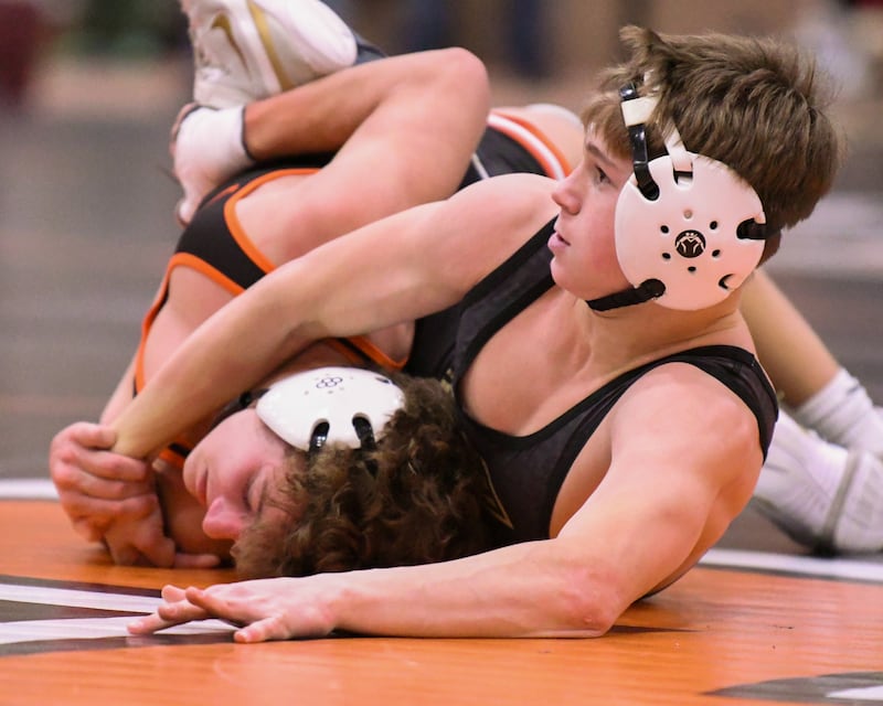 Sycamore’s wrestler Liam Schroeder tries to keep a hold of Lincoln-way West’s Kellan Hack during the 113-weight class on Monday Dec. 29, 2025 during the Flavin Invite held at DeKalb High School.