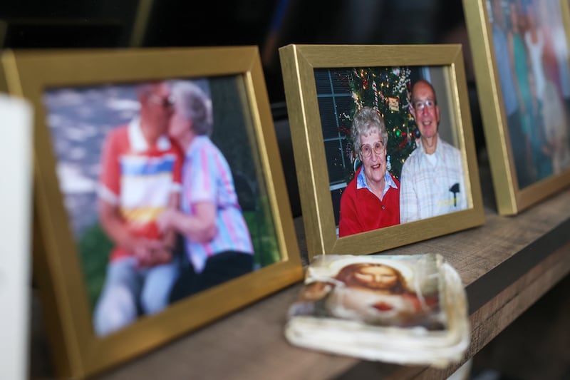 The prayer book used by Pat McCarty lays next to photos of Pat and her husband, Wayne, both of Bradley, on Tuesday, July 15, following the celebration of life services for the couple held July 14.