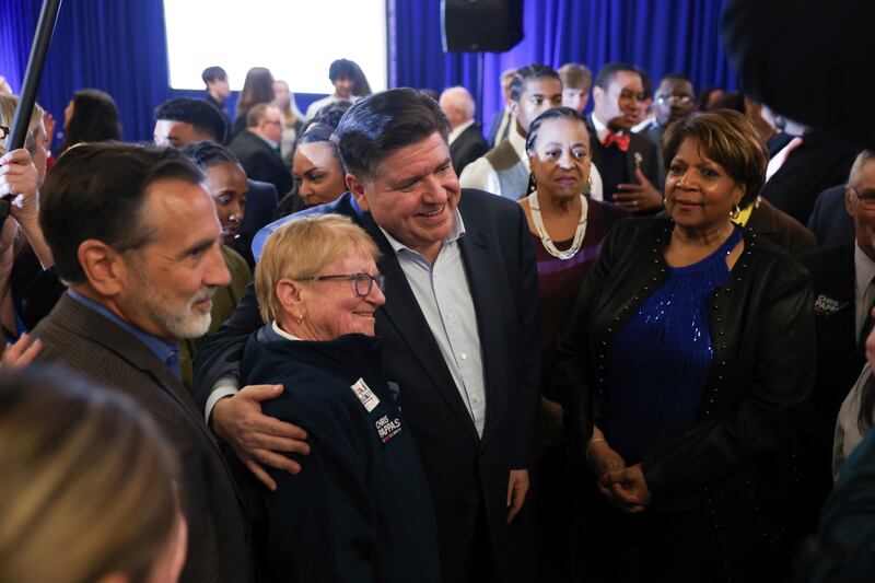 Illinois Gov. JB Pritzker, center, poses for a photo during the McIntyre-Shaheen 100 Club Dinner, Sunday April 27, 2025, in Manchester, N.H. (AP Photo/Reba Saldanha)